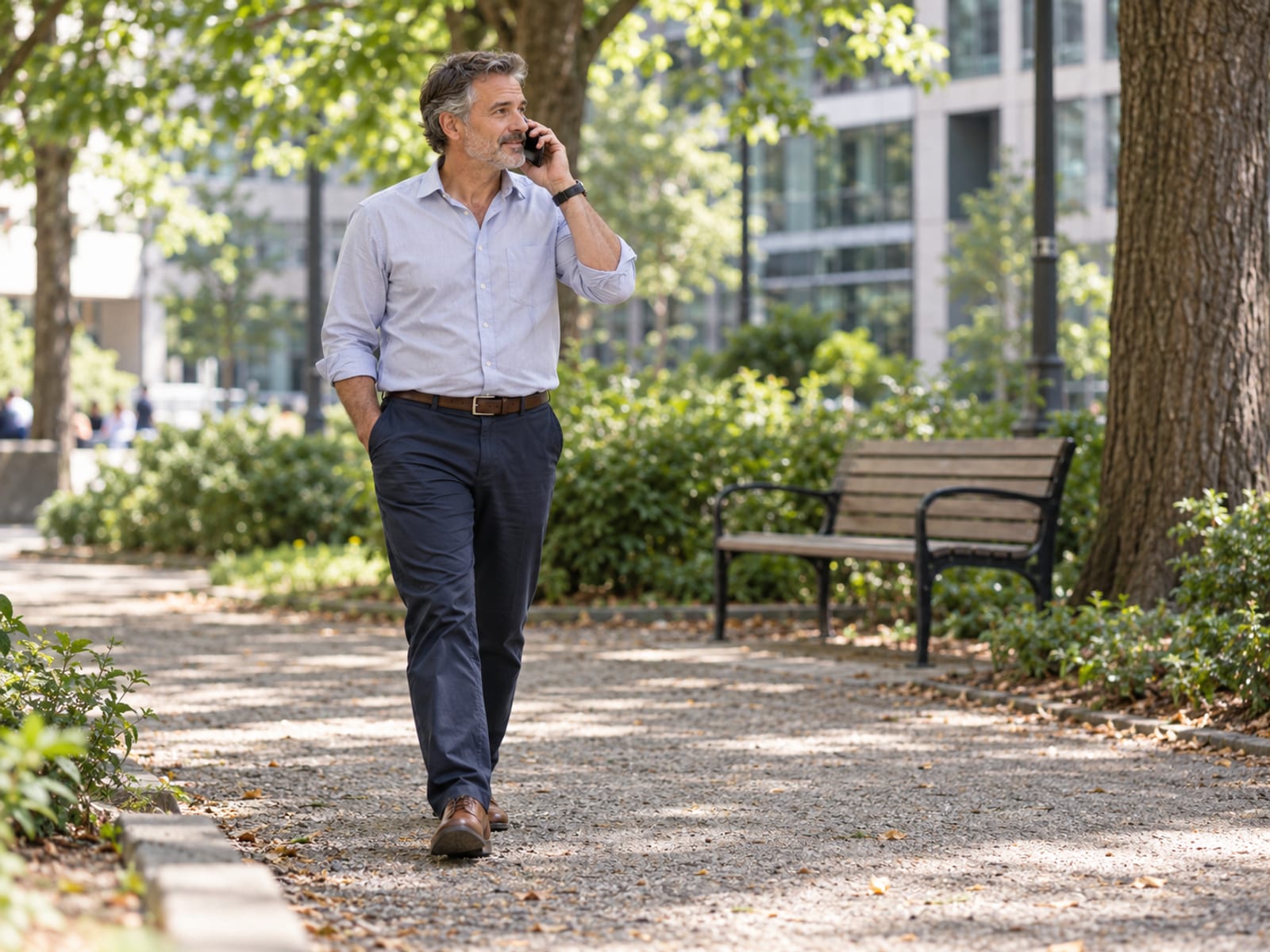 An office worker walking during a phone call in a nearby park